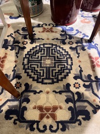 A Chinese Beijing rug with antiquities, floral design and stylized motifs, wool on cotton, 20th C.