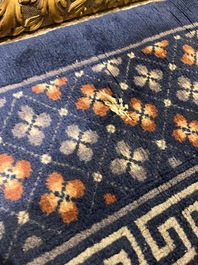 A Chinese Beijing rug with antiquities, floral design and stylized motifs, wool on cotton, 20th C.