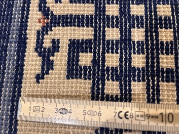 A Chinese Beijing rug with antiquities, floral design and stylized motifs, wool on cotton, 20th C.