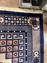 A Chinese Beijing rug with antiquities, floral design and stylized motifs, wool on cotton, 20th C.