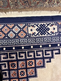 A Chinese Beijing rug with antiquities, floral design and stylized motifs, wool on cotton, 20th C.