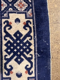 A Chinese Beijing rug with antiquities, floral design and stylized motifs, wool on cotton, 20th C.