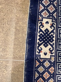 A Chinese Beijing rug with antiquities, floral design and stylized motifs, wool on cotton, 20th C.