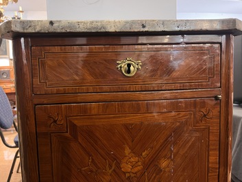 A pair of French Louis XVI style single door hall cabinets with floral marquetry, gilt bronze mounts and marble tops, 19th C.