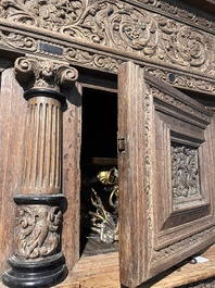 A Dutch elaborate carved oak Renaissance four-door cupboard, 17th C.