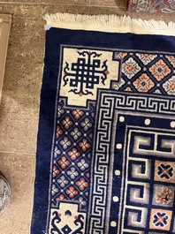 A Chinese Beijing rug with antiquities, floral design and stylized motifs, wool on cotton, 20th C.