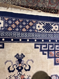 A Chinese Beijing rug with antiquities, floral design and stylized motifs, wool on cotton, 20th C.