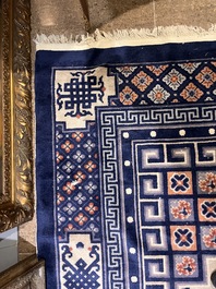 A Chinese Beijing rug with antiquities, floral design and stylized motifs, wool on cotton, 20th C.