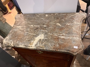 A pair of French Louis XVI style single door hall cabinets with floral marquetry, gilt bronze mounts and marble tops, 19th C.