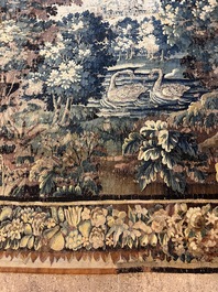 A Flemish verdure wall tapestry with two swans in a lake, probably Oudenaarde, late 17th C.