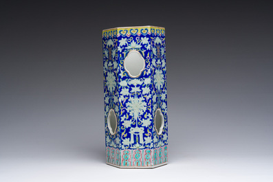 A Chinese reticulated hexagonal blue ground famille rose hatstand, 19th C.