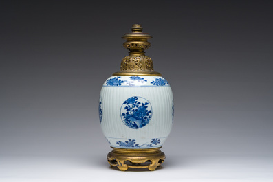 A Chinese blue and white vase with floral design with gilt bronze mounts mounted as a lamp, Kangxi