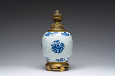 A Chinese blue and white vase with floral design with gilt bronze mounts mounted as a lamp, Kangxi