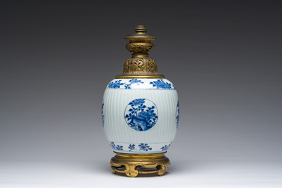 A Chinese blue and white vase with floral design with gilt bronze mounts mounted as a lamp, Kangxi