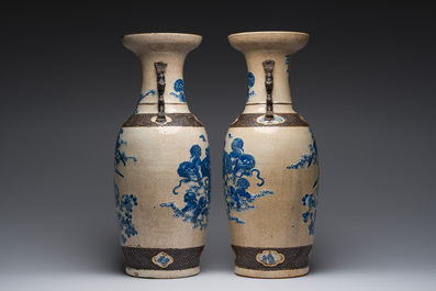 A pair of Chinese Nanking crackle glazed blue and white vases with Buddhist lions and birds among blossoming branches, 19th C.