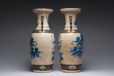 A pair of Chinese Nanking crackle glazed blue and white vases with Buddhist lions and birds among blossoming branches, 19th C.