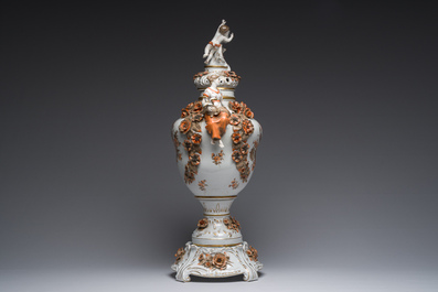 A large German polychrome and gilt decorated Saxon porcelain vase and cover on foot with relief design, Schierholz Plaue mark, 20th C.