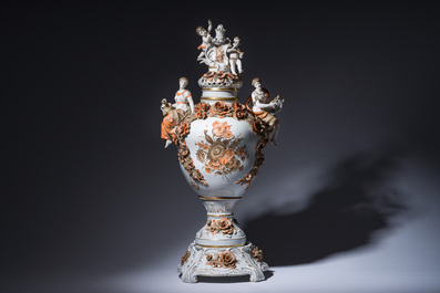 A large German polychrome and gilt decorated Saxon porcelain vase and cover on foot with relief design, Schierholz Plaue mark, 20th C.