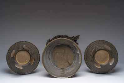 A Japanese three-piece bronze garniture with dragon relief design, Meiji, 19th C.