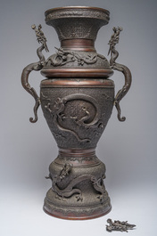 A Japanese three-piece bronze garniture with dragon relief design, Meiji, 19th C.