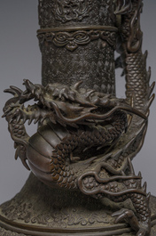 A Japanese three-piece bronze garniture with dragon relief design, Meiji, 19th C.