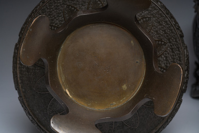 A Japanese three-piece bronze garniture with dragon relief design, Meiji, 19th C.