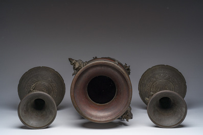 A Japanese three-piece bronze garniture with dragon relief design, Meiji, 19th C.