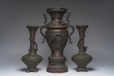 A Japanese three-piece bronze garniture with dragon relief design, Meiji, 19th C.