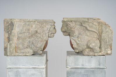 A pair of partly polychromed stone beam supports in the shape of lions holding coats of arms, probably Flanders, 16th/17th C.