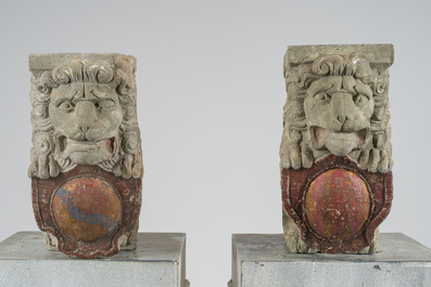 A pair of partly polychromed stone beam supports in the shape of lions holding coats of arms, probably Flanders, 16th/17th C.