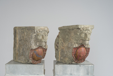 A pair of partly polychromed stone beam supports in the shape of lions holding coats of arms, probably Flanders, 16th/17th C.