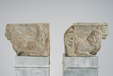 A pair of partly polychromed stone beam supports in the shape of lions holding coats of arms, probably Flanders, 16th/17th C.