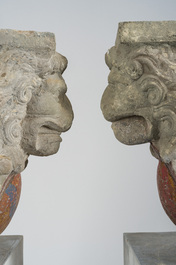 A pair of partly polychromed stone beam supports in the shape of lions holding coats of arms, probably Flanders, 16th/17th C.