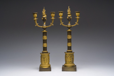 A pair of French Empire gilt and patinated bronze three-light candelabra, 19th C.