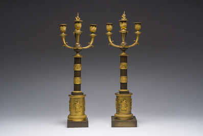 A pair of French Empire gilt and patinated bronze three-light candelabra, 19th C.