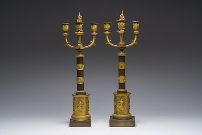 A pair of French Empire gilt and patinated bronze three-light candelabra, 19th C.