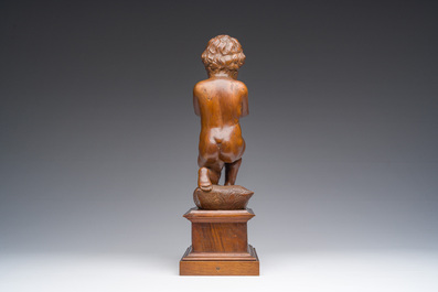 An Italian walnut sculpture of a youth kneeling on a cushion with floral design, 19th C.