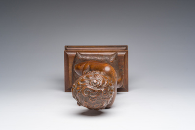 An Italian walnut sculpture of a youth kneeling on a cushion with floral design, 19th C.