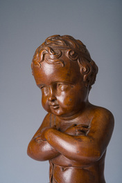 An Italian walnut sculpture of a youth kneeling on a cushion with floral design, 19th C.