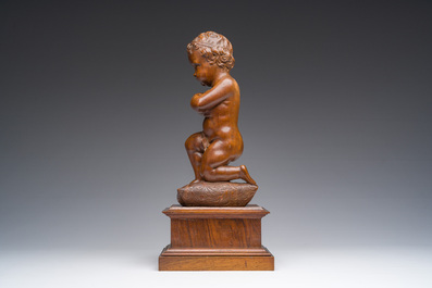 An Italian walnut sculpture of a youth kneeling on a cushion with floral design, 19th C.