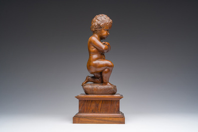 An Italian walnut sculpture of a youth kneeling on a cushion with floral design, 19th C.