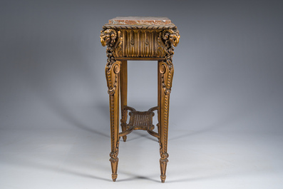 A French Louis XVI style gilt and carved woorden side table with ram's heads and a red marble top, 19th C.