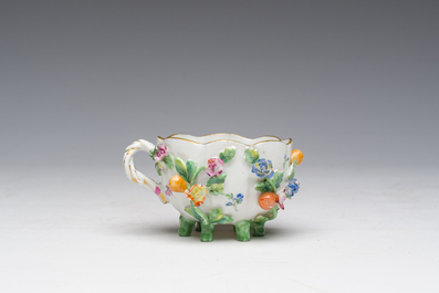 Two polychrome Saxon porcelain groups, a table piece and a cup and saucer, Germany, 19th/20th C.