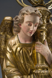 An impressive pair of polychrome decorated plaster angels mounted into ten-light candlesticks, 20th C.