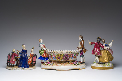 Two polychrome Saxon porcelain groups, a table piece and a cup and saucer, Germany, 19th/20th C.