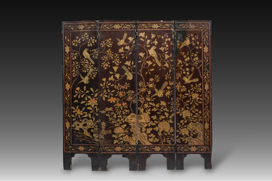 A Chinese four-panel lacquer coromandel screen with an animated scene and birds among blossoming branches, 19th/20th C.