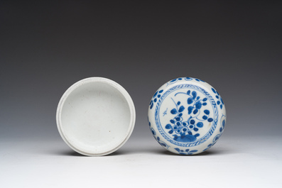A Chinese blue and white box and cover with floral design, a teapot stand and a famille rose 'Mandarin' spoon tray, Kangxi/Qianlong