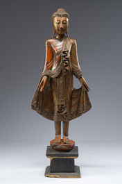 A tall Thai inlaid gilt lacquered wooden figure of a standing Buddha, 20th C.