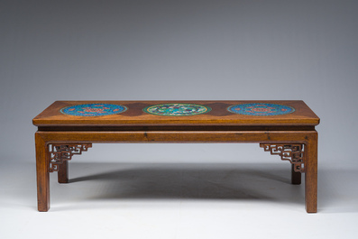 A Chinese rectangular wooden table inlaid with three round cloisonn&eacute; plaques with floral design, 20th C.