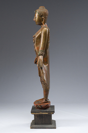 A tall Thai inlaid gilt lacquered wooden figure of a standing Buddha, 20th C.